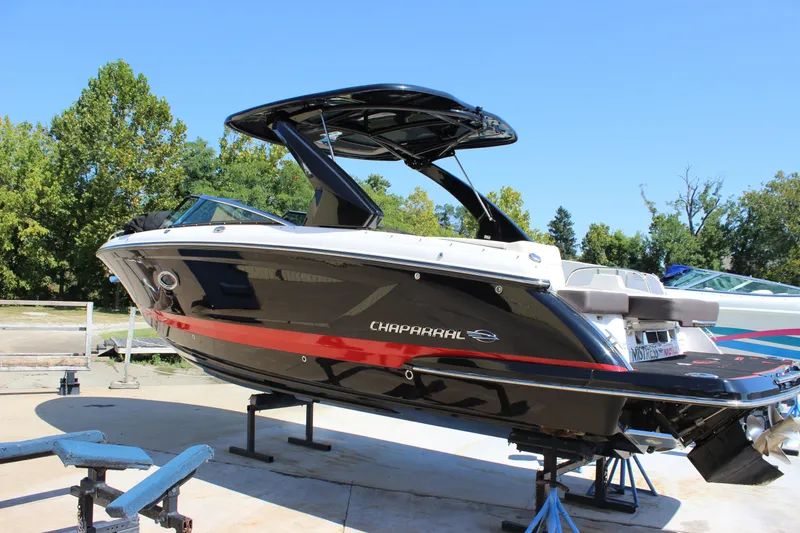 Slide: The Image of 2018 Chaparral 287 SSX boat on display, black with red accents, outdoors. - 44