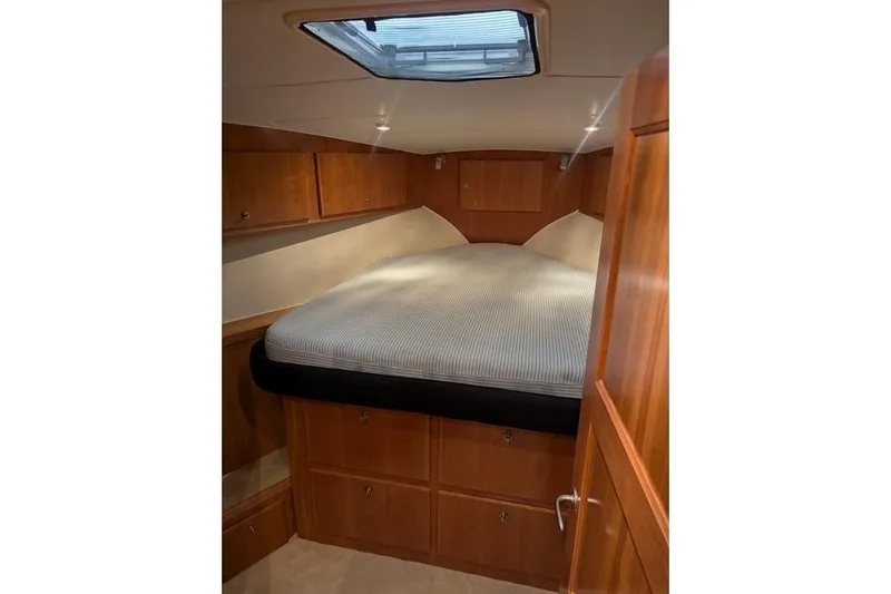 Slide: The Image of Luxurious 2004 Navigator 57 yacht cabin with wood paneling and skylight. - 10