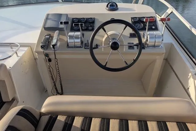 Slide: The Image of Helm of 2004 Navigator 57 yacht with steering wheel and control panel. - 11