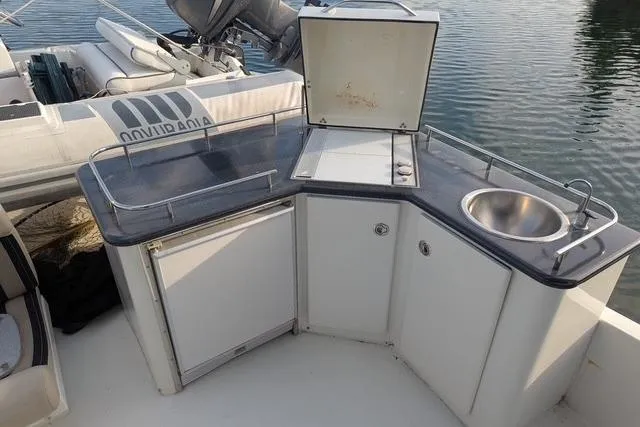 Slide: The Image of Outdoor kitchenette on 2004 Navigator 57 yacht with sink and storage. - 14