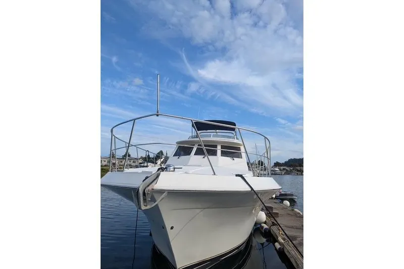 Slide: The Image of 2004 Navigator 57 yacht docked under a clear blue sky. - 18
