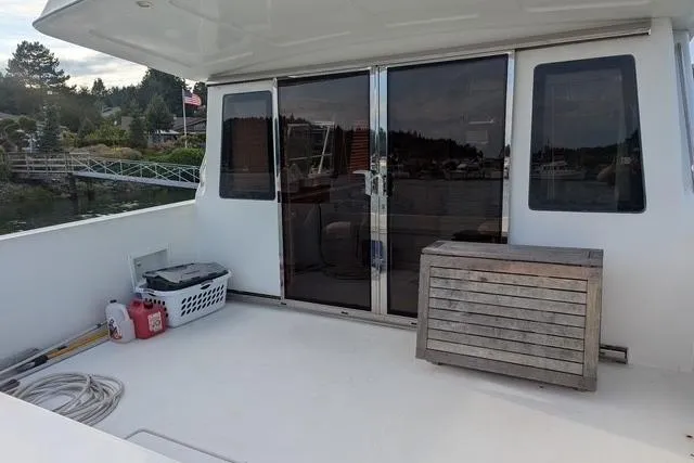 Slide: The Image of 2004 Navigator 57 yacht deck with sliding glass doors and outdoor storage. - 20