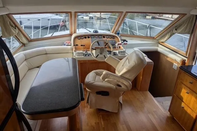 Slide: The Image of Luxurious 2004 Navigator 57 yacht interior with helm, leather seating, and panoramic windows. - 4
