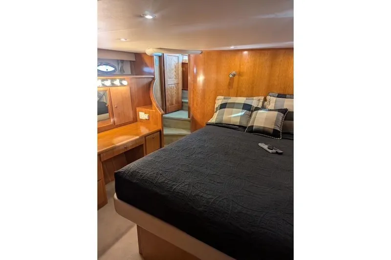 Slide: The Image of Luxurious 2004 Navigator 57 yacht bedroom with wood paneling and cozy bedding. - 6