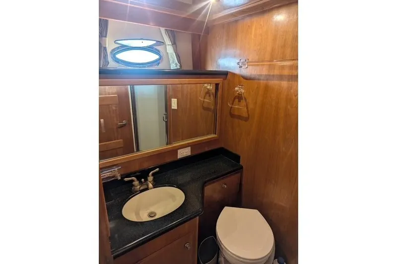 Slide: The Image of 2004 Navigator 57 yacht bathroom with wood paneling, sink, and toilet. - 8