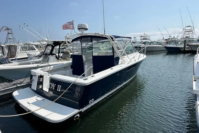 Slide: The Image of 2006 Tiara Yachts 2900 Coronet docked in a marina, clear sky background. - 1