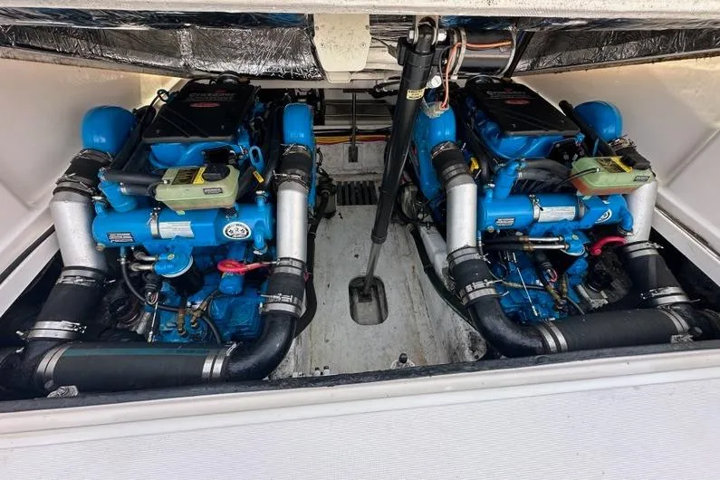Slide: The Image of Engine compartment of a 2006 Tiara Yachts 2900 Coronet, featuring dual blue engines. - 17