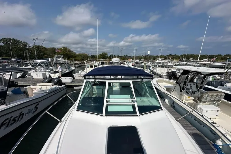 Slide: The Image of 2006 Tiara Yachts 2900 Coronet docked at marina under blue sky. - 23