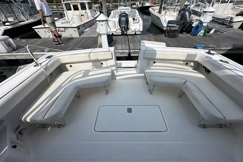 Slide: The Image of 2006 Tiara Yachts 2900 Coronet boat interior with white seating at a marina. - 26