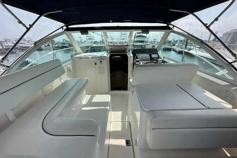 Slide: The Image of 2006 Tiara Yachts 2900 Coronet interior with seating and helm, docked at marina. - 3
