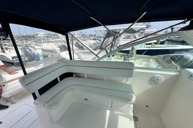 Slide: The Image of 2006 Tiara Yachts 2900 Coronet interior with white seating and marina view. - 4
