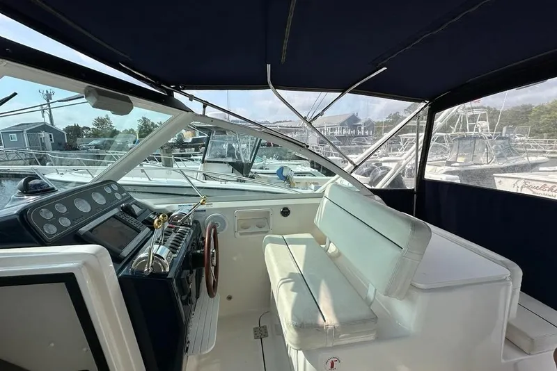 Slide: The Image of 2006 Tiara Yachts 2900 Coronet interior with helm and seating, docked at marina. - 5