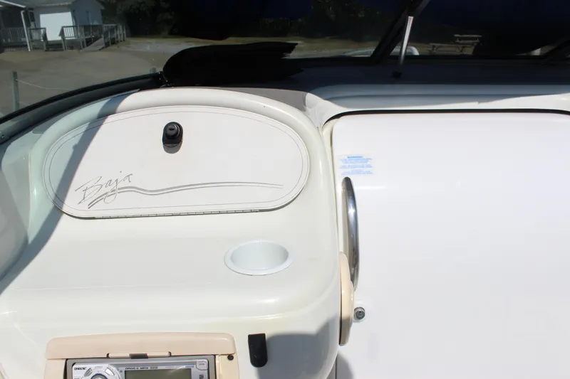 Slide: The Image of 1995 Baja 272 boat dashboard with stereo and cup holder. - 12