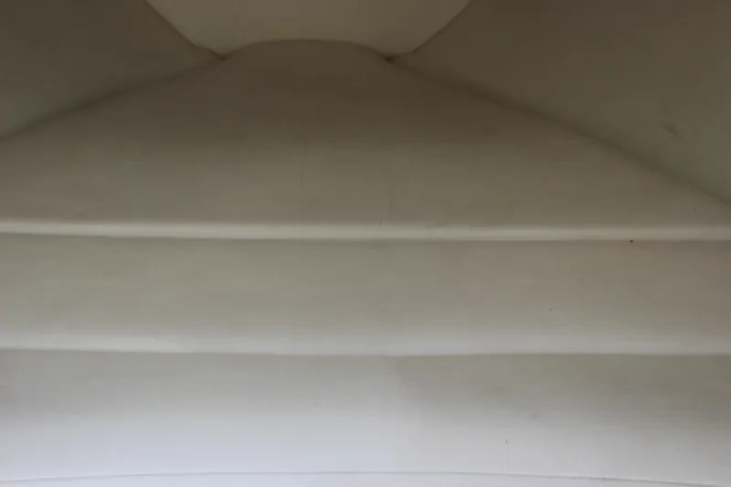 Slide: The Image of Interior view of a 1995 Baja 272 boat, showcasing white upholstery. - 18