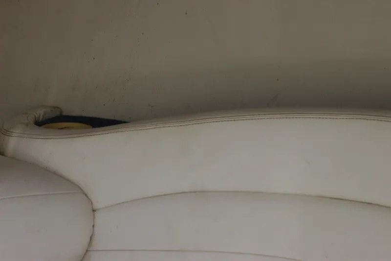 Slide: The Image of White leather interior of a 1995 Baja 272 boat, showing seat details. - 20