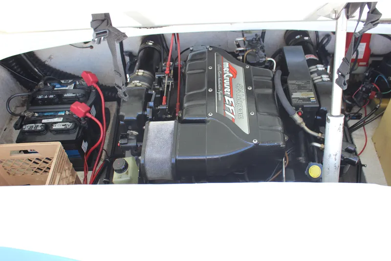 Slide: The Image of 1995 Baja 272 boat engine compartment with MerCruiser EFI engine and batteries. - 23