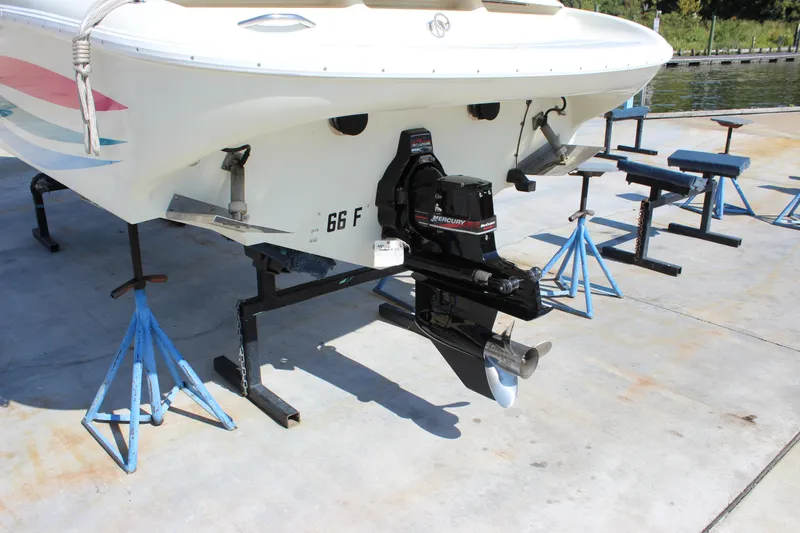 Slide: The Image of 1995 Baja 272 boat on stands, featuring a Mercury outboard motor. - 4