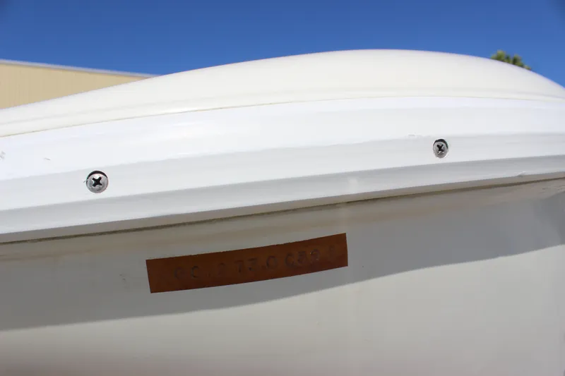 Slide: The Image of Close-up of a 1995 Baja 272 boat hull with visible screws and identification plate. - 9