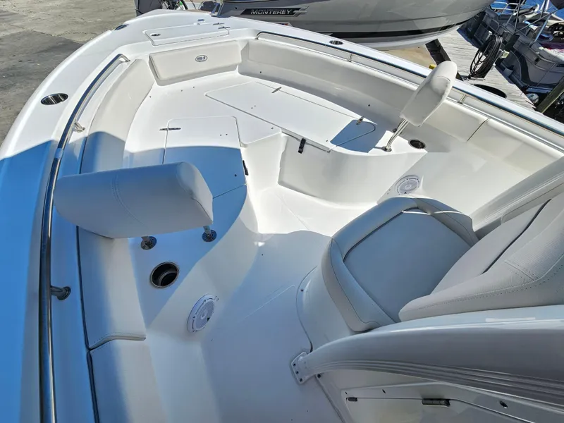 Slide: The Image of 2026 Sea Hunt Ultra 234 boat interior with white seating and spacious deck. - 14