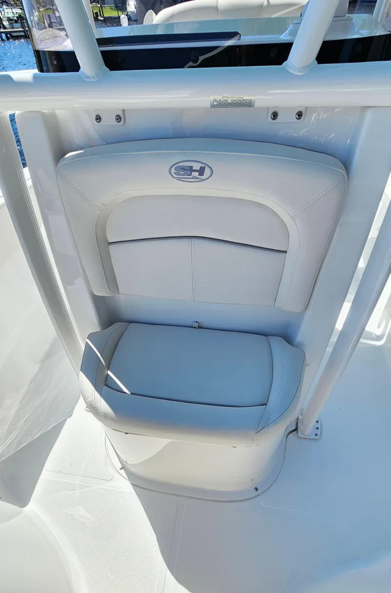 Slide: The Image of 2026 Sea Hunt Ultra 234 boat seat with white upholstery and sleek design. - 16