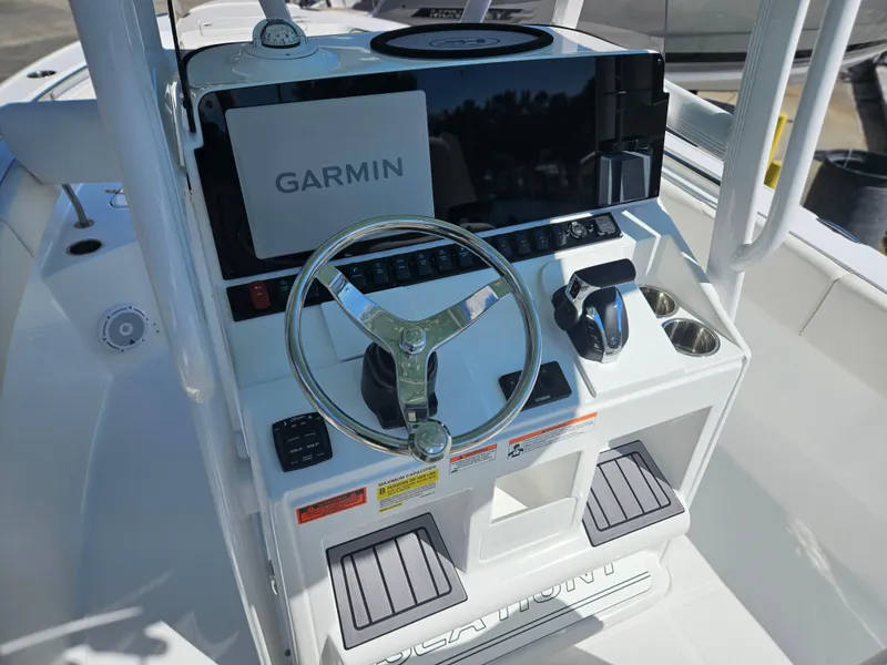 Slide: The Image of 2026 Sea Hunt Ultra 234 boat console with Garmin navigation system and steering wheel. - 23