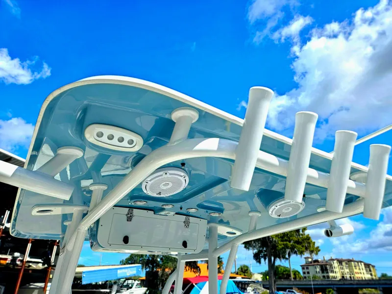 Slide: The Image of 2026 Sea Hunt Ultra 234 boat top with rod holders against a clear blue sky. - 9