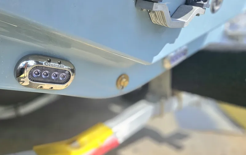 Slide: The Image of Close-up of 2026 Sea Hunt Ultra 234 boat's rear with LED light detail. - 10