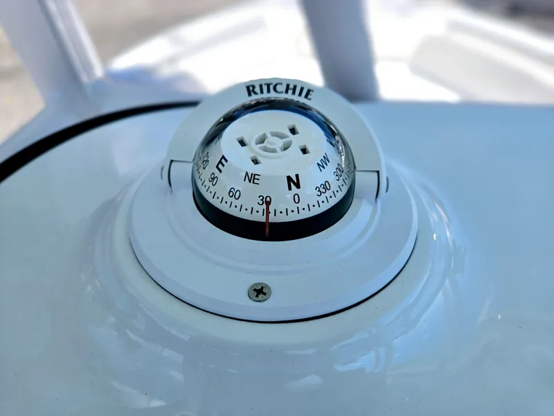Slide: The Image of Compass on 2026 Sea Hunt Ultra 234 boat dashboard, displaying cardinal directions. - 31
