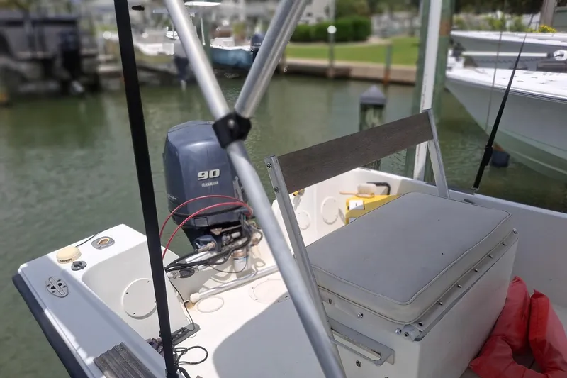 Slide: The Image of 1989 Mako 171 Center Console boat with Yamaha 90 engine, docked in marina. - 5