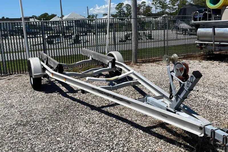 Slide: The Image of Boat trailer for 1989 Mako 171 Center Console, parked on gravel near a fence. - 9