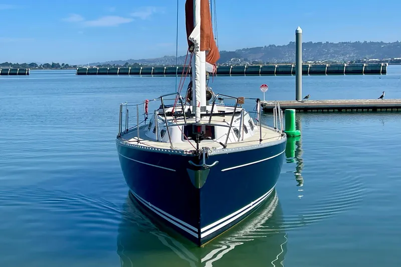 Slide: The Image of Sailboat Freedom 35, 1995 model, docked in calm marina waters. - 2