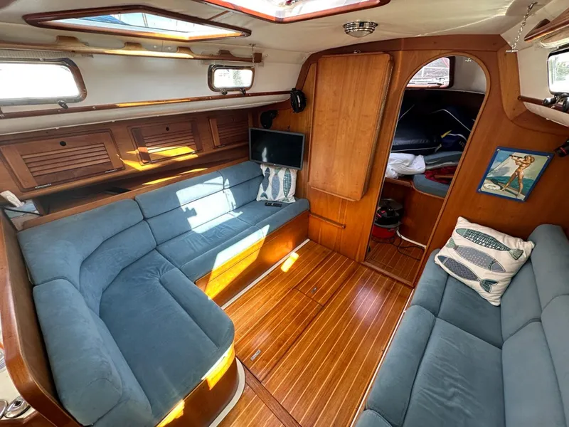 Slide: The Image of Interior of a 1995 Freedom 35 yacht with blue sofas. - 20
