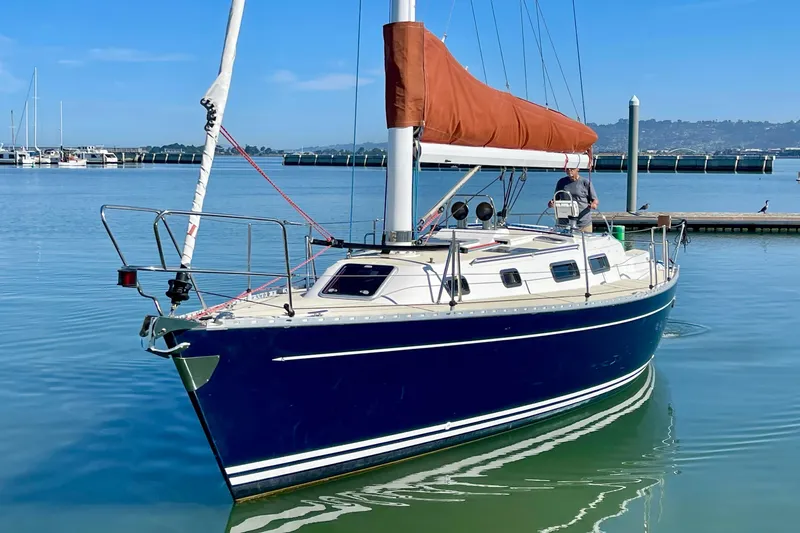 Slide: The Image of Sailboat Freedom 35, 1995 model, docked in calm marina waters. - 3
