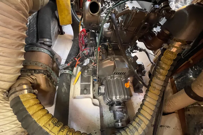 Slide: The Image of Engine compartment of a 1995 Freedom 35 sailboat, featuring hoses and mechanical components. - 35