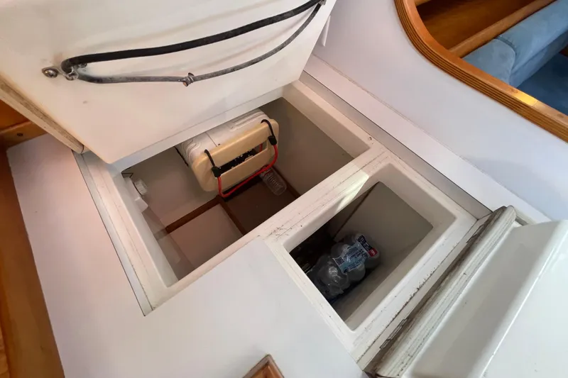 Slide: The Image of Open storage compartment in 1995 Freedom 35 boat interior, showing organized space and equipment. - 36