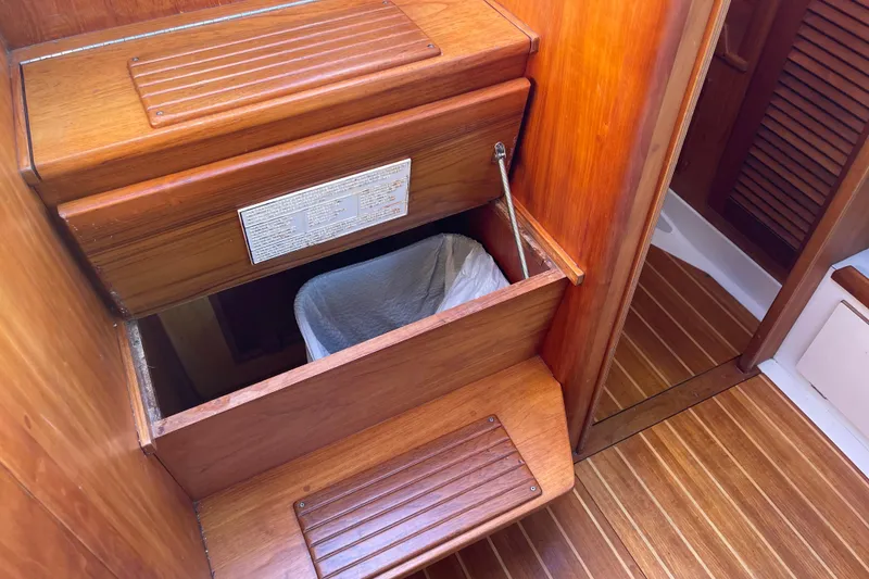 Slide: The Image of Wooden interior of a 1995 Freedom 35 boat with built-in storage compartment. - 37
