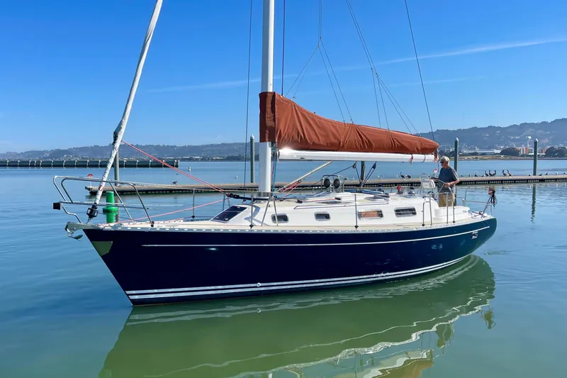 Slide: The Image of Sailboat Freedom 35, 1995 model, docked in calm waters under clear blue sky. - 4