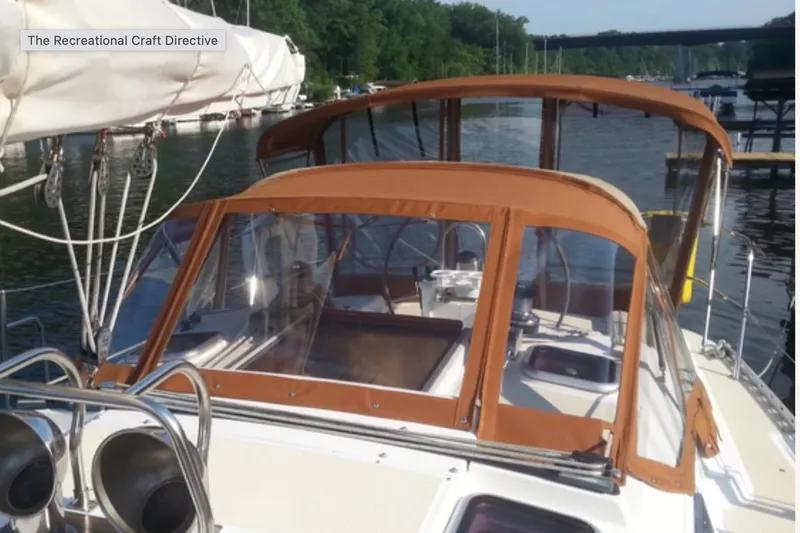 Slide: The Image of Sailboat Freedom 35, 1995 model, docked with brown canopy and clear windows. - 45