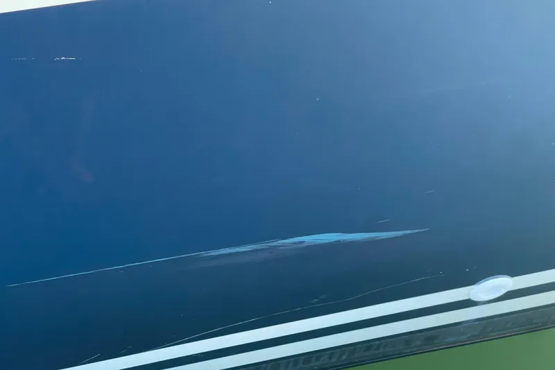 Slide: The Image of Close-up of a 1995 Freedom 35 boat hull with visible scratches. - 50