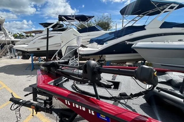 Slide: The Image of 2022 Tracker Pro Team 190 TX Tournament Edition boat in marina, surrounded by other boats. - 13