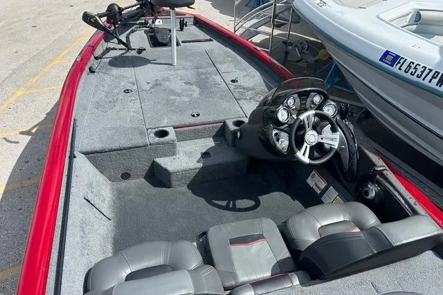 Slide: The Image of 2022 Tracker Pro Team 190 TX Tournament Edition boat with red trim and dual seating. - 18