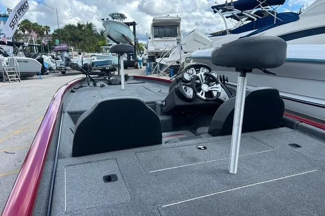 Slide: The Image of 2022 Tracker Pro Team 190 TX Tournament Edition boat interior at a marina. - 22