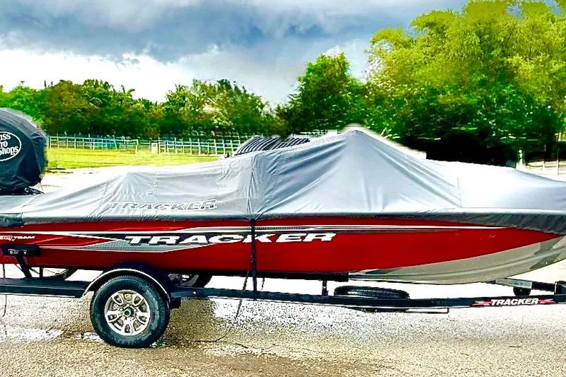 Slide: The Image of 2022 Tracker Pro Team 190 TX Tournament Edition boat covered, parked on trailer. - 32