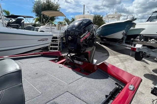 Slide: The Image of 2022 Tracker Pro Team 190 TX Tournament Edition boat with Mercury engine, parked among other boats. - 6