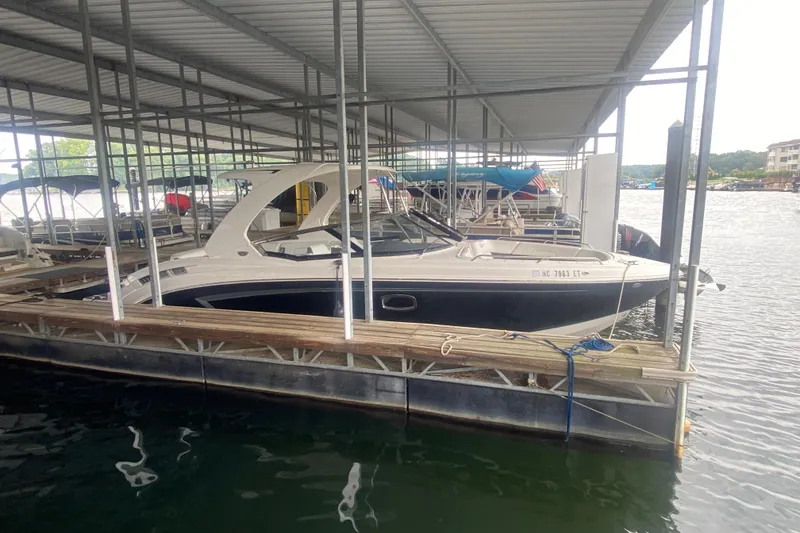 Slide: The Image of 2015 Chaparral 307 SSX boat docked in a covered marina. - 3