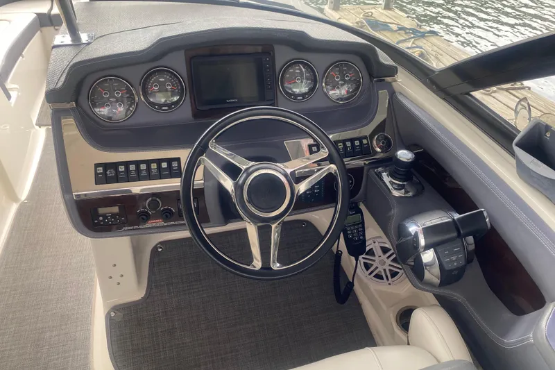 Slide: The Image of 2015 Chaparral 307 SSX boat dashboard with steering wheel and control panel. - 5
