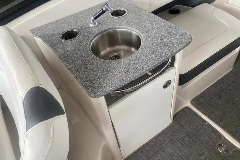 Slide: The Image of 2015 Chaparral 307 SSX boat interior with sink and seating area. - 8