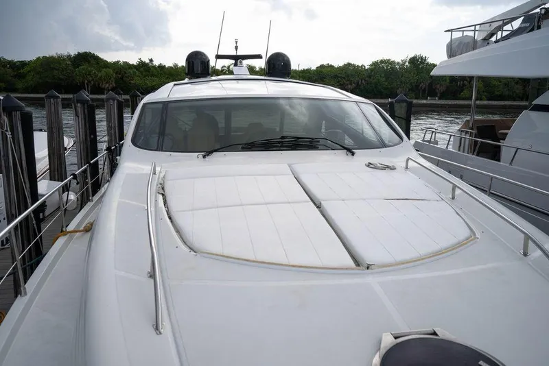 Slide: The Image of 2007 Pershing 62' yacht docked, showcasing sleek design and modern features. - 13