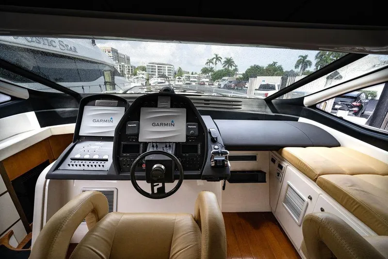 Slide: The Image of Luxurious 2007 Pershing 62' yacht cockpit with Garmin navigation system and plush seating. - 17