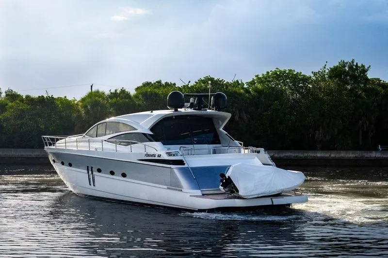 Slide: The Image of 2007 Pershing 62' yacht cruising on a calm waterway with lush greenery. - 24